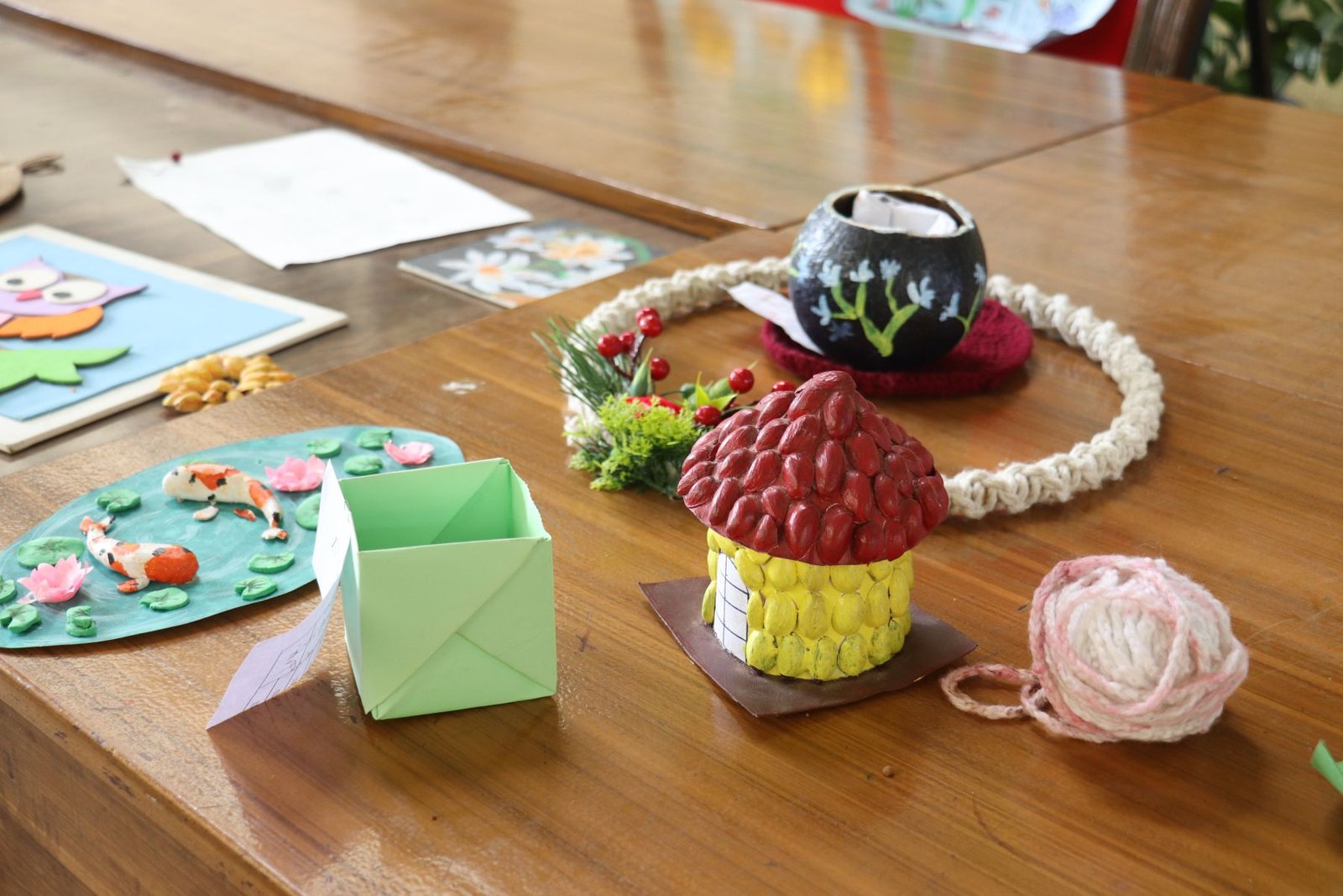 Colorful student crafts made with reused and natural materials