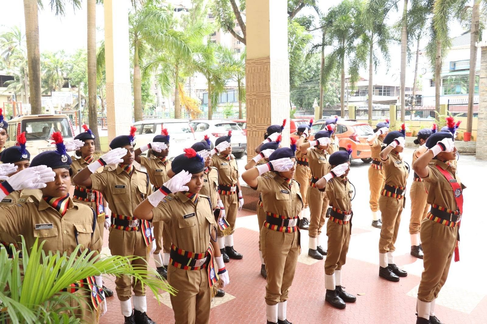 Student police cadets saluting together